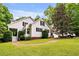 Charming two-story home with a well-manicured lawn and mature landscaping at 7212 Avalon Dr, Douglasville, GA 30135