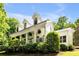 Charming home featuring a columned front porch with hanging plants and dormer windows at 7212 Avalon Dr, Douglasville, GA 30135