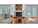Close up of the cozy living room fireplace with hardwood floors and French doors at 7212 Avalon Dr, Douglasville, GA 30135