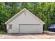 A two-car detached garage with a white door and white siding at 7212 Avalon Dr, Douglasville, GA 30135