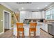 Charming kitchen with central island, tiled floor, light cabinetry, and modern stainless steel appliances at 7212 Avalon Dr, Douglasville, GA 30135