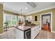 Spacious kitchen with an island, wine cooler, light cabinetry, offering ample counter space and modern amenities at 7212 Avalon Dr, Douglasville, GA 30135