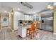 Well-lit kitchen with an island, stainless steel appliances and neutral countertops offering modern convenience and style at 7212 Avalon Dr, Douglasville, GA 30135