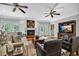 Cozy living room with fireplace, hardwood floors, ceiling fans, and neutral paint at 7212 Avalon Dr, Douglasville, GA 30135