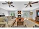 Comfortable living room features a fireplace, ceiling fans, hardwood floors and French doors at 7212 Avalon Dr, Douglasville, GA 30135