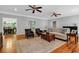 Spacious living room featuring hardwood floors, ceiling fans, and view into dining room at 7212 Avalon Dr, Douglasville, GA 30135