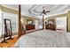 Beautiful main bedroom with hardwood floors, tray ceiling, four-poster bed, and plenty of natural light at 7212 Avalon Dr, Douglasville, GA 30135