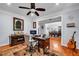 The office space has a desk, chair, guitar and looks into the formal dining room at 7212 Avalon Dr, Douglasville, GA 30135