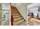 Inviting carpeted staircase with wood railing leading to the living area at 7212 Avalon Dr, Douglasville, GA 30135
