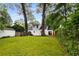 Backyard with a large lawn, trees, and swing, showcasing the spacious outdoor living area of this home at 1981 N Decatur Ne Rd, Atlanta, GA 30307