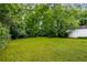 A sprawling back yard featuring mature trees and lush green grass, creating a private outdoor oasis at 1981 N Decatur Ne Rd, Atlanta, GA 30307