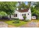 Attractive one-story home featuring a well-kept lawn and detached garage, all surrounded by mature trees at 1981 N Decatur Ne Rd, Atlanta, GA 30307