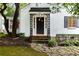 Close-up of the front door with black door, decorative ironwork, and meticulously maintained landscaping at 1981 N Decatur Ne Rd, Atlanta, GA 30307