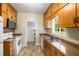 Kitchen with laminate counters, wood cabinetry, and white appliances at 1981 N Decatur Ne Rd, Atlanta, GA 30307