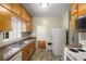 Kitchen with wood cabinets, white appliances, and a stainless steel sink at 1981 N Decatur Ne Rd, Atlanta, GA 30307