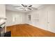 Open living room with hardwood floors, a ceiling fan, fresh paint, and a classic fireplace, bathed in natural light at 1981 N Decatur Ne Rd, Atlanta, GA 30307