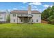 Spacious backyard with well-maintained lawn and a deck, perfect for outdoor entertaining at 4591 Millstone Walk Ne Dr, Buford, GA 30519