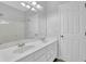 Bright bathroom featuring a double sink vanity, large mirror, and white walls at 4591 Millstone Walk Ne Dr, Buford, GA 30519