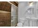 Bathroom featuring a tiled shower with glass door and a pedestal sink at 4591 Millstone Walk Ne Dr, Buford, GA 30519