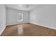 Bedroom features a ceiling fan, hardwood floors and a large window at 4591 Millstone Walk Ne Dr, Buford, GA 30519