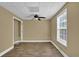Neutral bedroom featuring a ceiling fan, and natural light from a window at 4591 Millstone Walk Ne Dr, Buford, GA 30519