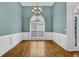 Dining room with hardwood floors, chandelier, wainscotting and a large window at 4591 Millstone Walk Ne Dr, Buford, GA 30519