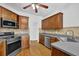 This kitchen features wood floors, gray countertops, tile backsplash and stainless steel appliances at 4591 Millstone Walk Ne Dr, Buford, GA 30519