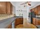 Traditional kitchen with wooden cabinetry, stainless steel appliances, and gray countertops at 4591 Millstone Walk Ne Dr, Buford, GA 30519