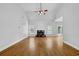 Living room with vaulted ceilings, fireplace, hardwood flooring, and plenty of windows at 4591 Millstone Walk Ne Dr, Buford, GA 30519