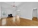 Bright living room with fireplace, hardwood flooring, vaulted ceilings, and french doors at 4591 Millstone Walk Ne Dr, Buford, GA 30519
