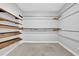 Walk-in closet with custom wood shelving and metal racks at 4591 Millstone Walk Ne Dr, Buford, GA 30519