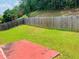 A well-maintained backyard featuring green grass, a wooden fence, and mature trees for privacy and outdoor enjoyment at 5123 Upper Elm St, Atlanta, GA 30349