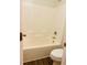 Bathroom with a toilet and bathtub featuring a seamless, easy-to-clean design at 5123 Upper Elm St, Atlanta, GA 30349