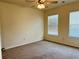Carpeted bedroom with two bright windows and ceiling fan at 5123 Upper Elm St, Atlanta, GA 30349