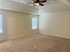 Carpeted bedroom with ceiling fan and natural light streaming through a window at 5123 Upper Elm St, Atlanta, GA 30349
