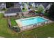 An inviting community pool area with a gated fence, playground, and ample seating, perfect for recreation and relaxation at 5123 Upper Elm St, Atlanta, GA 30349