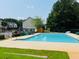 A sparkling community pool with lounge chairs and lush greenery, creating a perfect spot for relaxation and summertime fun at 5123 Upper Elm St, Atlanta, GA 30349
