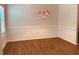 Elegant dining room featuring paneled walls, hardwood flooring, and a decorative chandelier at 5123 Upper Elm St, Atlanta, GA 30349