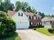 Attractive two-story home featuring a mix of brick and siding, a spacious driveway, and lush landscaping at 5123 Upper Elm St, Atlanta, GA 30349