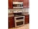Contemporary kitchen with modern stainless steel double oven and dark wood cabinets at 5123 Upper Elm St, Atlanta, GA 30349