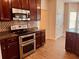 Well-equipped kitchen featuring stainless steel appliances, mosaic backsplash, and dark cabinets at 5123 Upper Elm St, Atlanta, GA 30349