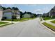 A quiet residential street showcasing well-maintained homes and lush landscaping, creating a welcoming neighborhood atmosphere at 5123 Upper Elm St, Atlanta, GA 30349