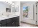 Stylish bathroom featuring a modern vanity, large mirror, and bright window at 6 Stratford Hall Ne Pl, Atlanta, GA 30342