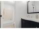 Cozy bathroom featuring tile floors, bathtub, and an oval mirror above vanity at 6 Stratford Hall Ne Pl, Atlanta, GA 30342