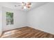 Bright bedroom with hardwood floors, a ceiling fan, and a window offering natural light at 6 Stratford Hall Ne Pl, Atlanta, GA 30342
