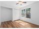 Bedroom with wood floors, a large closet, and a window with trees outside at 6 Stratford Hall Ne Pl, Atlanta, GA 30342