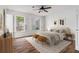 Cozy bedroom with hardwood floors, ceiling fan, and sunlit windows at 6 Stratford Hall Ne Pl, Atlanta, GA 30342