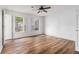 Bright bedroom featuring hardwood floors, two windows and white trim at 6 Stratford Hall Ne Pl, Atlanta, GA 30342