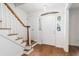 Inviting entryway featuring hardwood floors and a staircase with wooden banister at 6 Stratford Hall Ne Pl, Atlanta, GA 30342