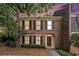 Charming two-story brick home with classic black shutters and a welcoming arched entryway at 6 Stratford Hall Ne Pl, Atlanta, GA 30342